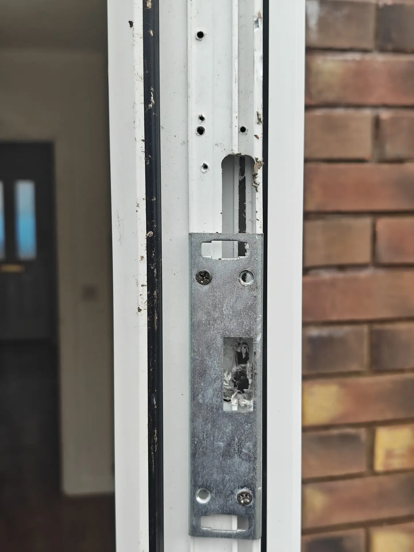 Worn UPVC door keep plate showing damaged lock point housing — Champs Locksmiths, Swansea